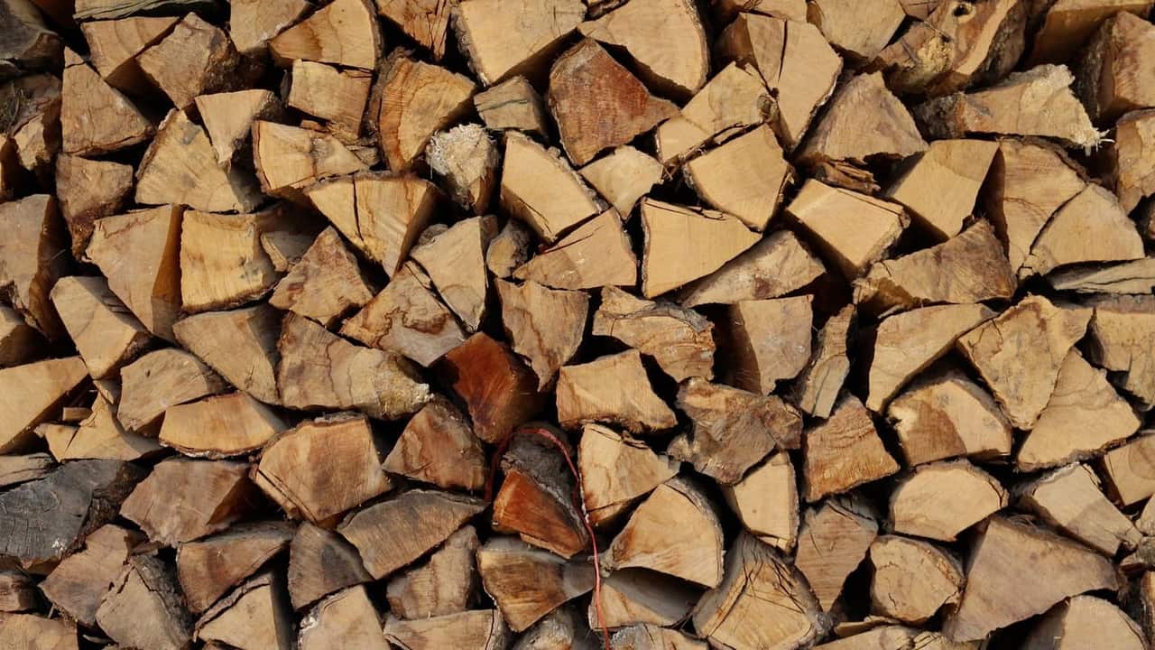 A neat stack of split firewood logs seasoned and ready for winter heating